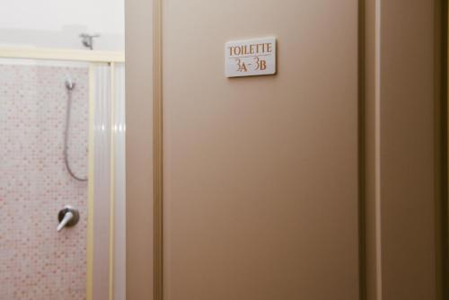 a bathroom door with a toilet sign on it at Boteroom Relais in La Volla