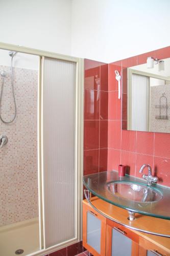 a bathroom with a sink and a shower at Boteroom Relais in La Volla