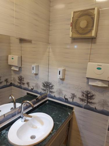 a bathroom with a sink and a mirror at Good Season Hotel in Cairo