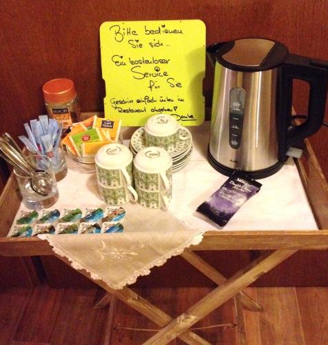 a table with a coffee maker on top of it at Antjes Schmankerlhotel und Restaurant in Tröstau