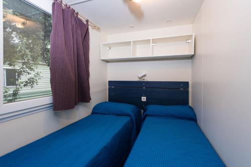 Postel nebo postele na pokoji v ubytování The charming Mare Pineta Mobile home 4 persons