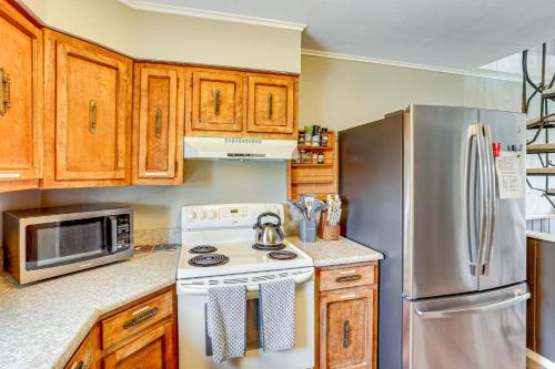 a kitchen with a stove and a refrigerator at 2 Mtn-View Decks and Natural Spring Durango Retreat in Durango