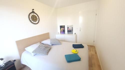 a bedroom with a bed with a yellow toy on it at Cosy carré Haussmann, stade de franc, C D G, Paris in Le Blanc-Mesnil
