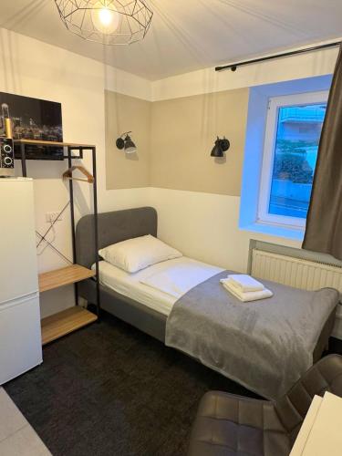 a small bedroom with a bed and a window at Stilvolle Apartments in Bonn I home2share in Bonn