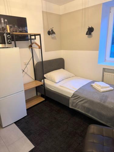 a small bedroom with a bunk bed and a refrigerator at Stilvolle Apartments in Bonn I home2share in Bonn