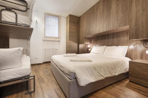 a large bedroom with two beds and a television at Genziana 2 - AffittiPontediLegno in Ponte di Legno