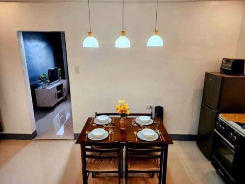 a kitchen with a table and two chairs and a table and a stove at Villa Mendoza Residence B in San Jose