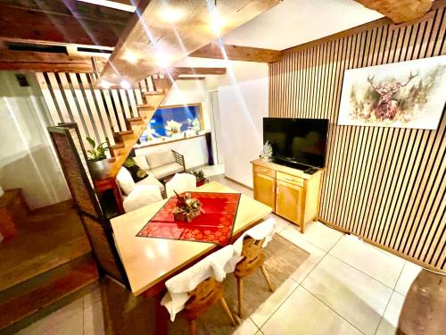 a living room with a table and a television at Villa Evy in Mutters