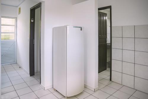a white refrigerator in a room with two doors at Pousada Schmitz in Florianópolis
