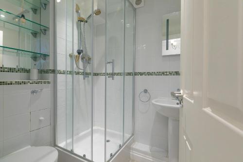 a bathroom with a shower and a toilet and a sink at Ocean View in Carbis Bay