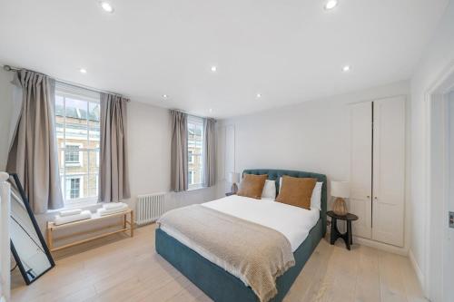 a bedroom with a bed and a large window at New stylish 3-Bed Pimlico House near Big Ben in London