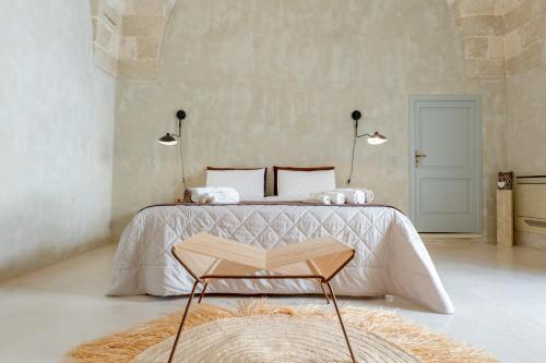 a bedroom with a bed with a book on it at Palazzo Angelica - Luxury Retreat Otranto in Giurdignano