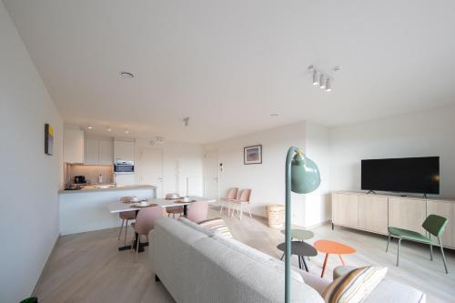 a living room with a couch and a table at H&D at Sea in Blankenberge