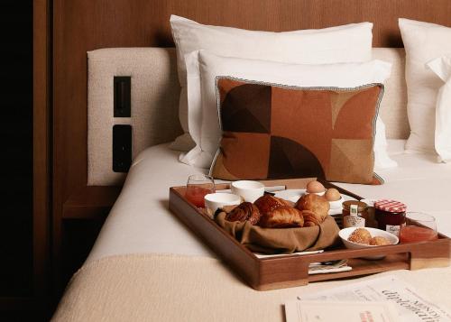 a tray of food on top of a bed at HIGHSTAY Maisons - Boétie in Paris