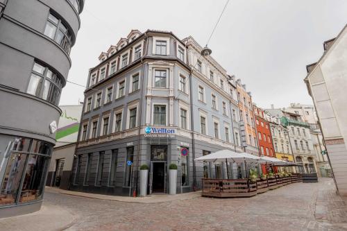 a large building on a street in a city at Wellton Centrum Hotel & SPA in Rīga