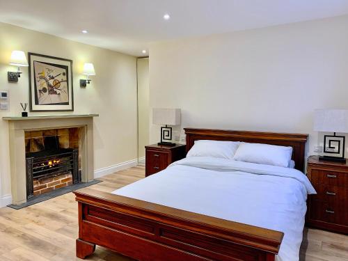 a bedroom with a large bed and a fireplace at Swafield Hall in Swafield