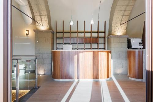 a lobby with a counter in the middle of a room at Agriturismo Santa Rosa in Lubriano