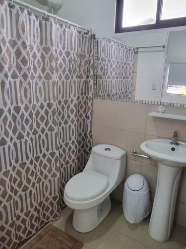a bathroom with a toilet and a sink at Villas Azul in Tamarindo
