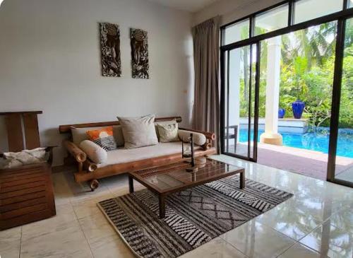 a living room with a couch and a coffee table at Heavenly place in Surin Beach