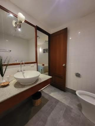 a bathroom with a sink and a toilet and a mirror at Heavenly place in Surin Beach