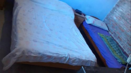 a bed in a room with a pillow on it at Alquiler de Casa El Rulo in Miramar