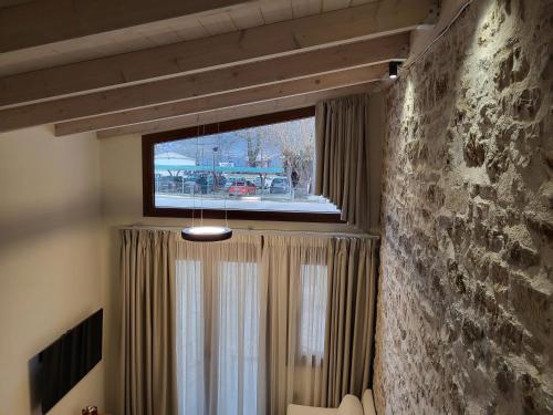a room with a window with curtains and a television at 1929 Boutique Residences in Ioannina