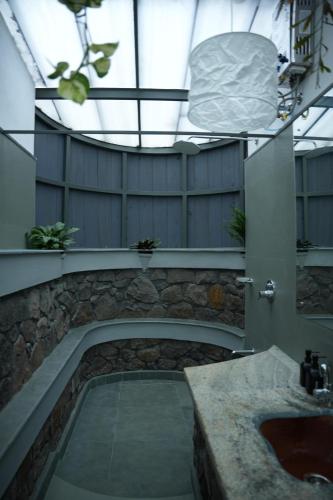a large bathroom with a sink and a tub at Malhar - Your Home Beneath The Clouds in Sultan Bathery