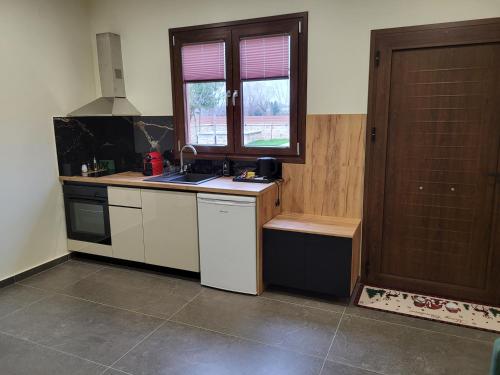 a kitchen with a sink and a stove and a window at 1929 Boutique Residences in Ioannina