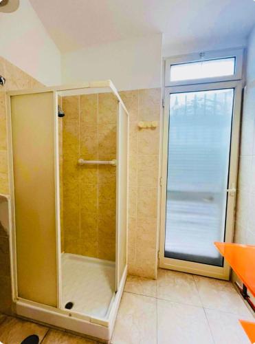 a shower with a glass door in a bathroom at Casa Vacanza Margherita B&B in Acerra