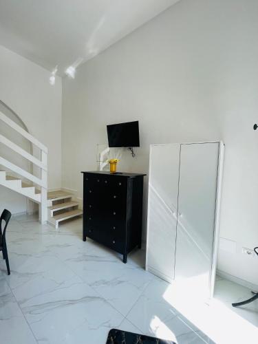 a white room with a dresser and a mirror at Casa Vacanza Margherita B&B in Acerra