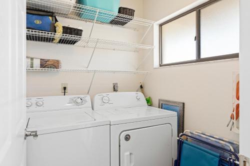 a laundry room with two washer and dryer at Bridgeport Condo 209 in Bradenton Beach