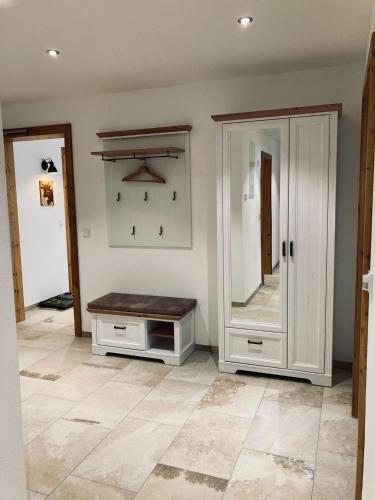 a room with a mirror and a cabinet and a counter at Ilgerhof Ferienwohnungen in Oberaudorf