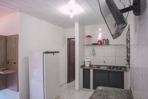 a kitchen with a stove and a refrigerator at Pousada Schmitz in Florianópolis
