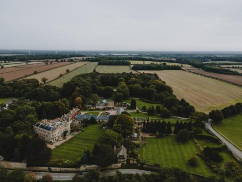 an aerial view of a mansion with a field and trees at Stable Arches Boutique B&B at Hooton Pagnell Hall in Doncaster