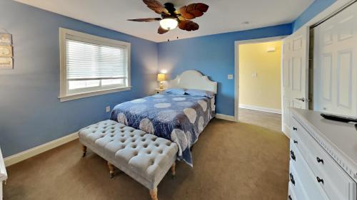 a bedroom with a bed and a ceiling fan at Put-in-Bay Waterfront Condo #106 in Put-in-Bay