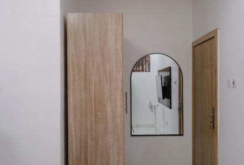 a mirror on a wall next to a door at Luxury 3 bedroom Apartment in Surulere in Surulere