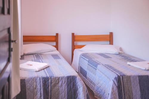 two beds sitting next to each other in a room at Pousada Schmitz in Florianópolis
