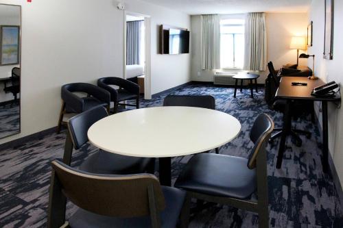 a hotel room with a table and chairs at Fairfield Inn & Suites by Marriott Charleston Airport/Convention Center in Charleston