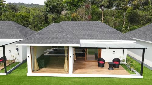 a house with a gazebo with a roof at The Winterfell Premium Homestay By Dazzle Destinations in Somvārpet