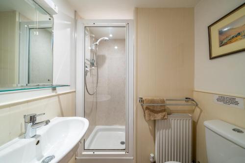 a bathroom with a sink and a shower at Ghyll Foot - At the foot of Place Fell, Ullswater in Patterdale
