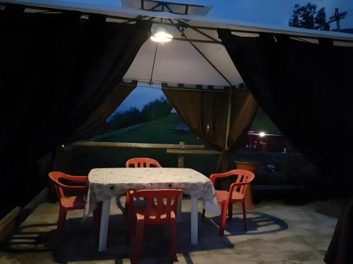 a table and four chairs in a tent at Casa Chamonin Pila in Gressan