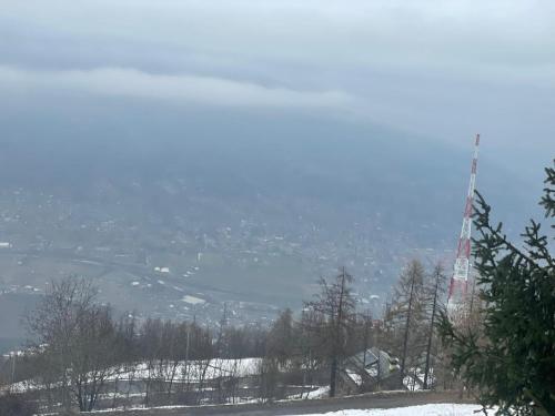 a view of a snow covered hill with a city at Casa Chamonin Pila in Gressan