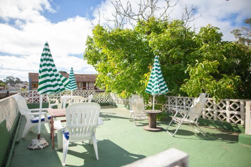 a group of chairs and tables on a patio at Las Grullas in Villa Gesell