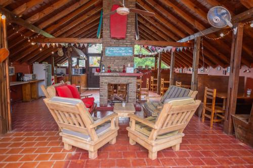 a living room with two chairs and a fireplace at Las Grullas in Villa Gesell