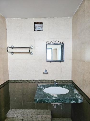 a bathroom with a sink and a mirror at Rivasa Resort 5 mins to Calangute Beach in Calangute