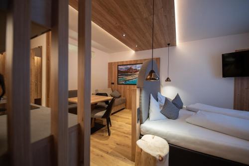 a small room with a bed and a table at Hotel Mondschein in Sesto