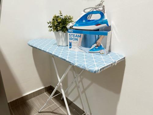 a small table with a sign iron on it at BF Stay 2 in Kuala Terengganu