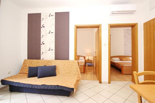 a hotel room with a bed and a bedroom at Apartments Limun Zarok in Baška