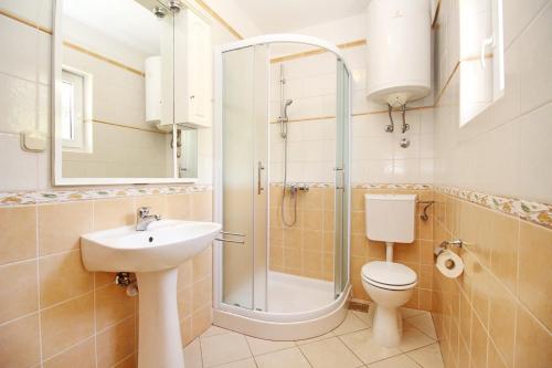 a bathroom with a sink toilet and a shower at Apartments Limun Zarok in Baška