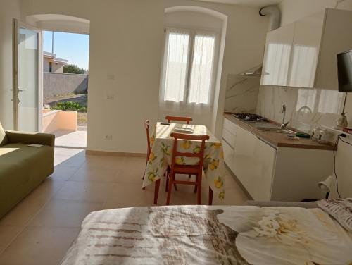 a kitchen and dining room with a table and chairs at Casa Cristina in Ventimiglia